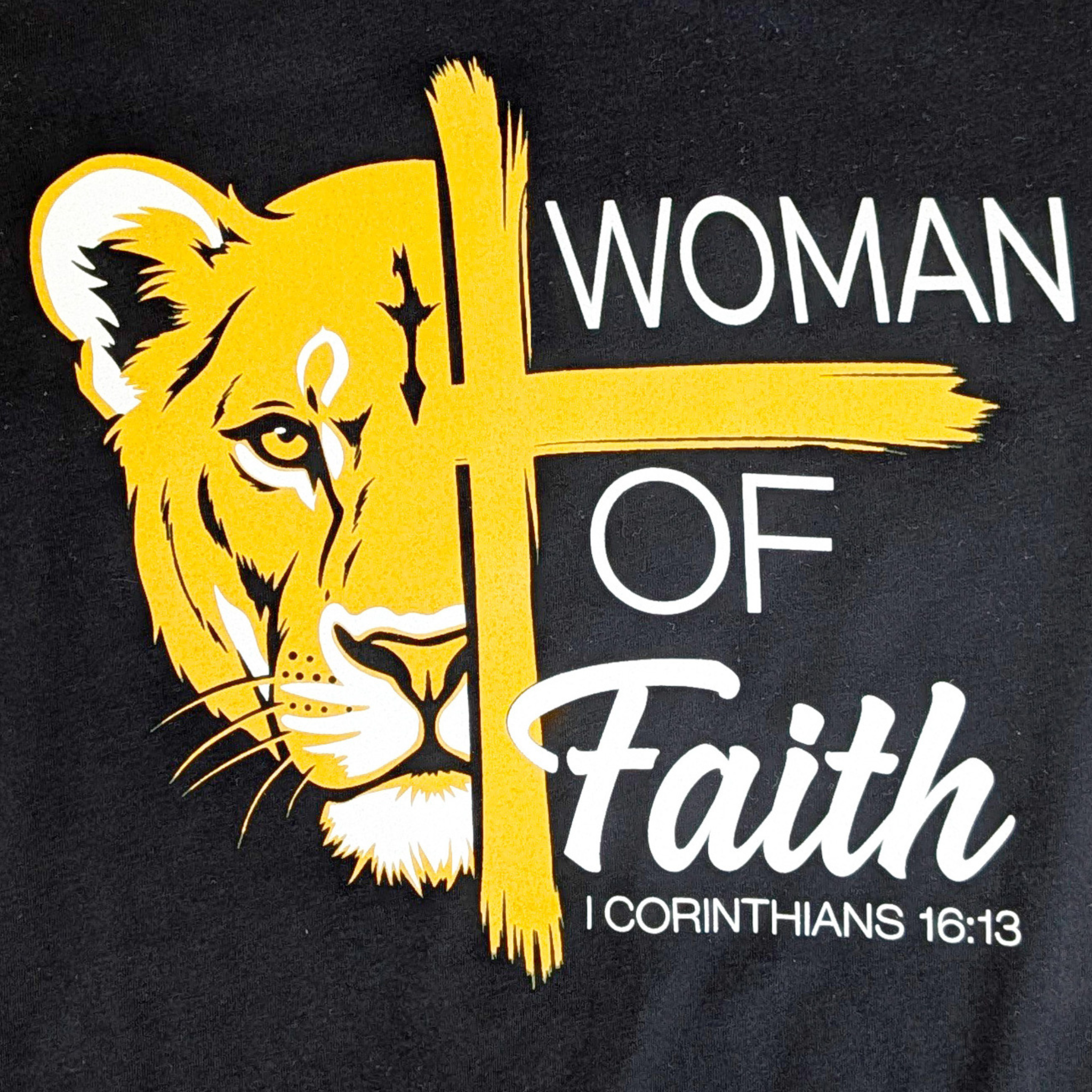 Black t-shirt with yellow lion graphic and 'Woman of Faith' text on a black background